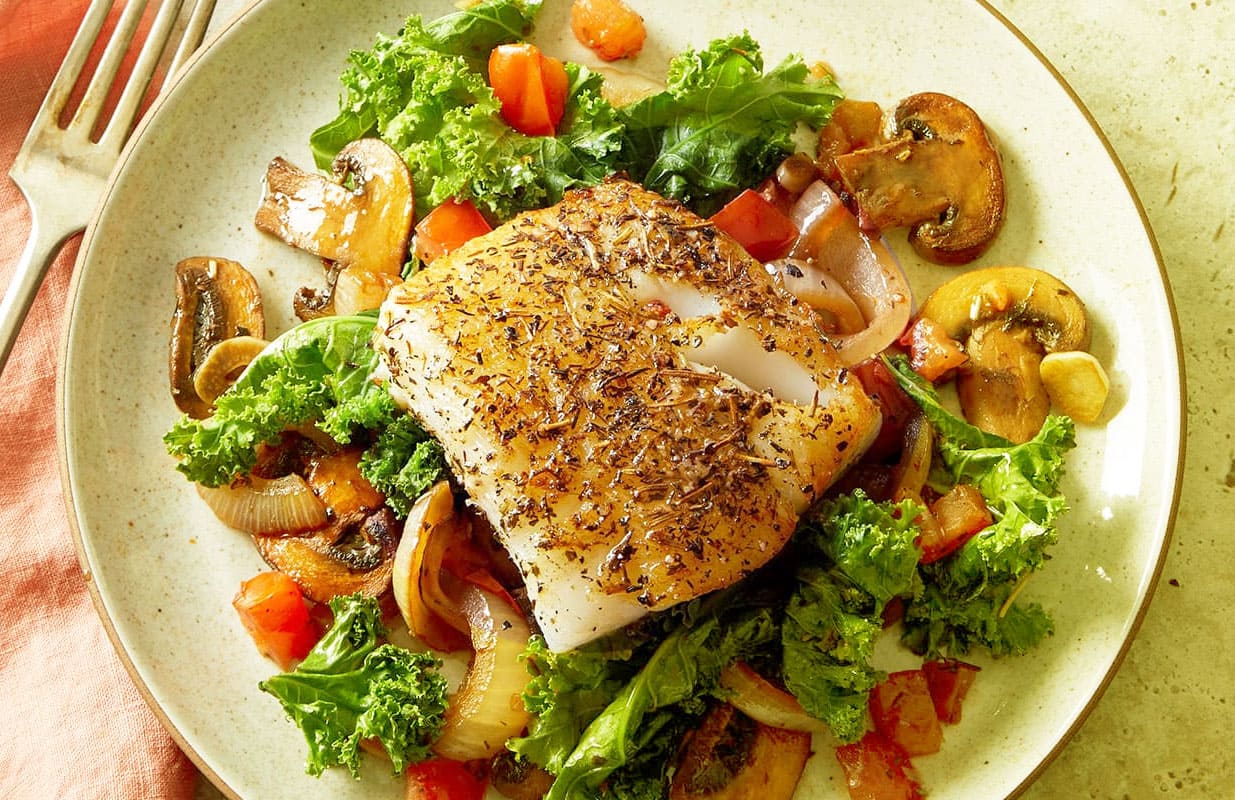 Mediterranean Herb-Dusted Fish with Wilted Greens and Mushrooms